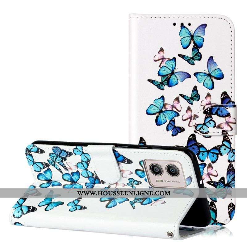 Housse Moto G73 5G Papillons Bleus en Vol à Lanière